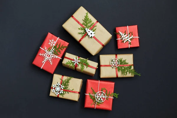 Christmas handmade red gift boxes on dark background top view. Merry christmas greeting card. Happy New Year. Flat lay.