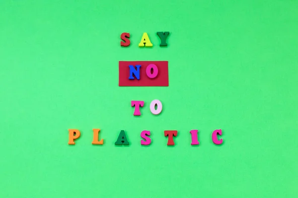 Say NO to plastic - on green background. Environmental, pollution concept