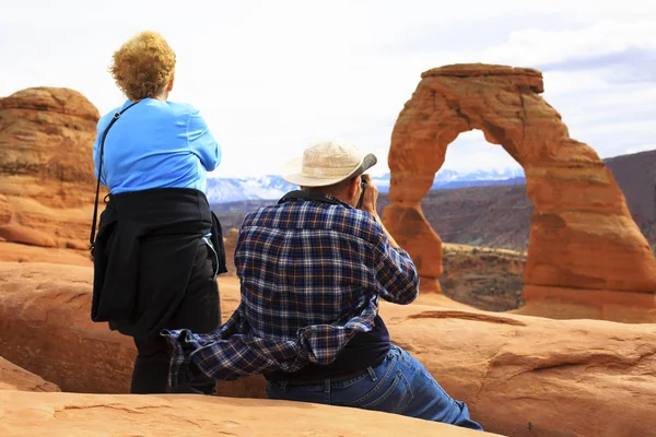 Seniors couple enjoying the beauty of Delicate Arch, Utah, Stock Picture