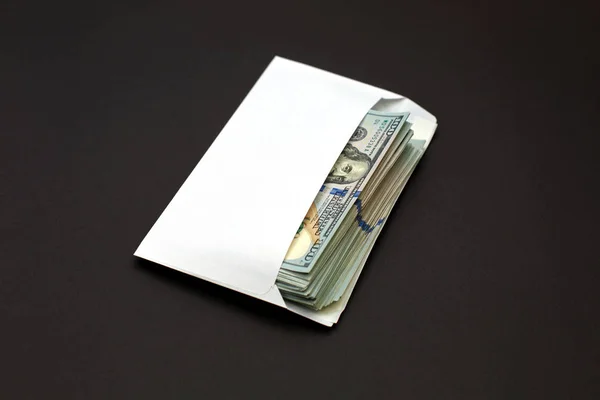 Dollar money in the envelope on black background bonus, reward, benefits concept.
