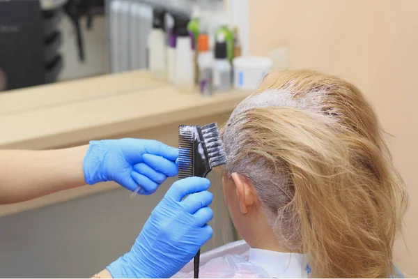 Process of dyeing hair at beauty salon, closeup