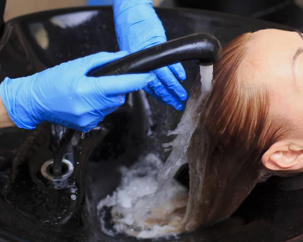 girl in a beauty salon. wash your hair, hair care, health.