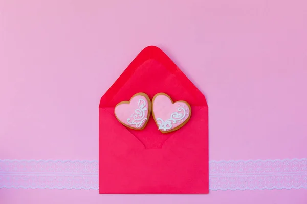 Red letter envelope with two cookies heart-shape on pink background, love, romance, Valentines\' Day concept