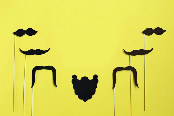 Happy Father's Day. image of a man on paper. Beard and mustache on yellow background. Concept of prostate cancer