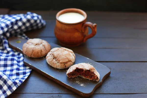 Cookies and milk. Top view of a cookie and cup of milk on a wooden background