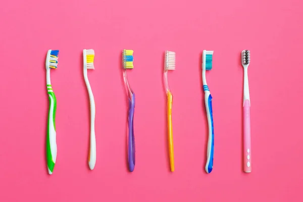 Set of different toothbrushes on pink background. — Stock Photo, Image