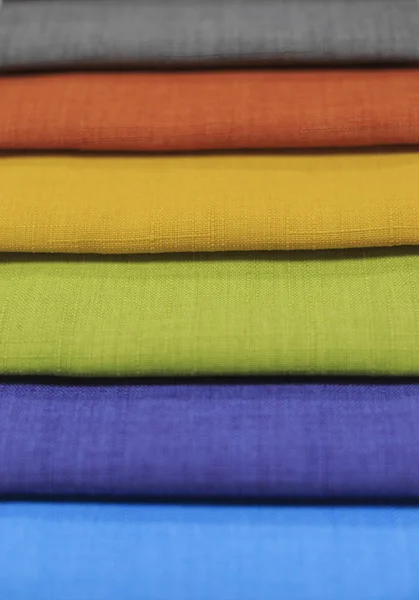 Textile samples. Textile samples for curtains. Yellow, blue, orange, green tone curtain samples hanging.