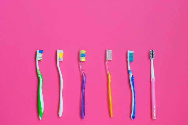 Set of different toothbrushes on pink background. — Stock Photo, Image