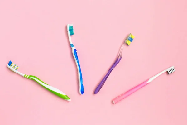Set of different toothbrushes on green background. Personal care concept. Flat lay. — Stock Photo, Image