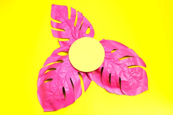 Three painted tropical palm leaf of monstera on yellow background. fashion pink concept. minimalism. Summer concept.