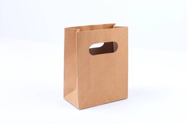 Recycled empty, kraft brown paper shopping bag on white background clipart