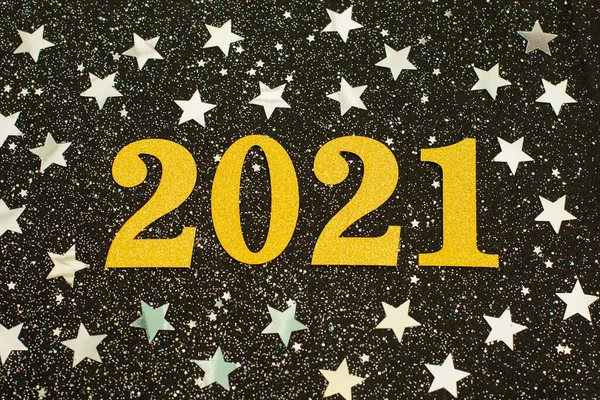 Happy New year 2021 with silwer glitter stars on black background. Holiday party decoration. New year celebration. holiday background