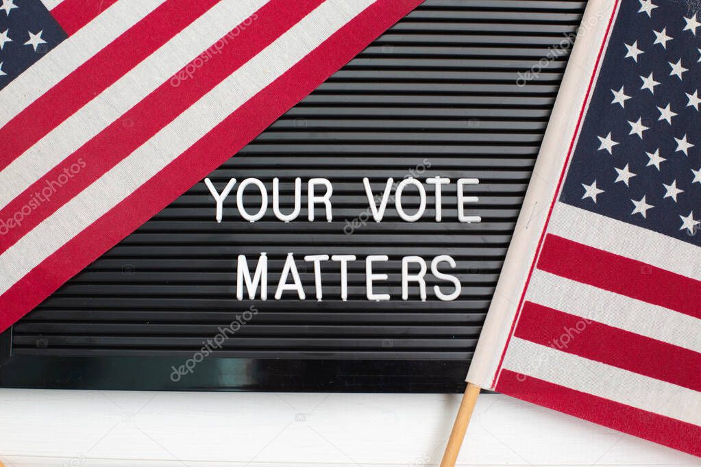 Letterboard sign with the words YOUR VOTE MATTERS with American flag. US elections.