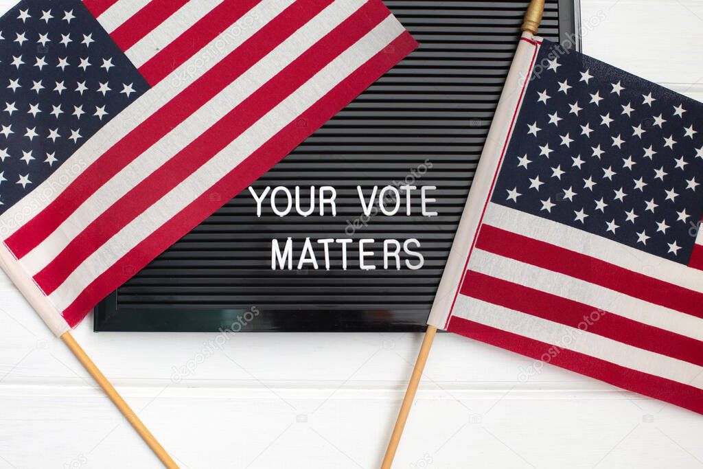 Letterboard sign with the words YOUR VOTE MATTERS with American flag. US elections.