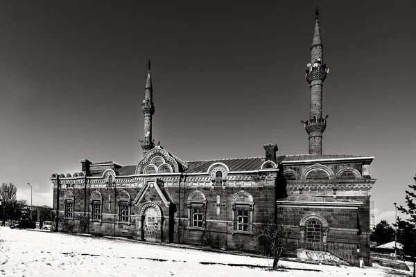 The mosque surrounded by the church in the city center of Kars