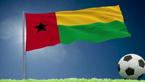 Guinea-Bissau flag fluttering and football rolls — Stock Video
