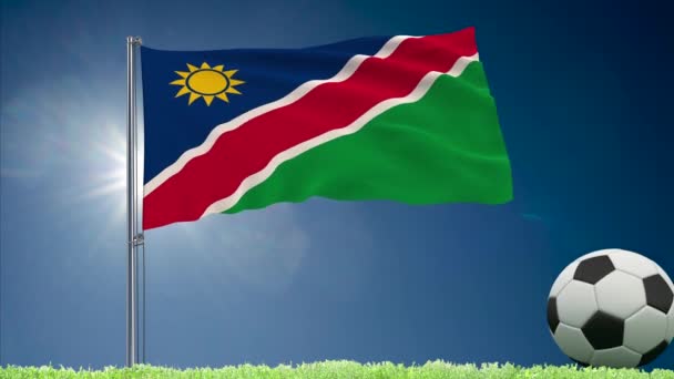 Drapeau namibien flottant et rouleaux de football — Video