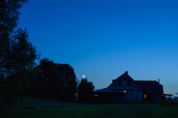 Dorfhaus mit Schornstein und Mondsichel — Stockfoto