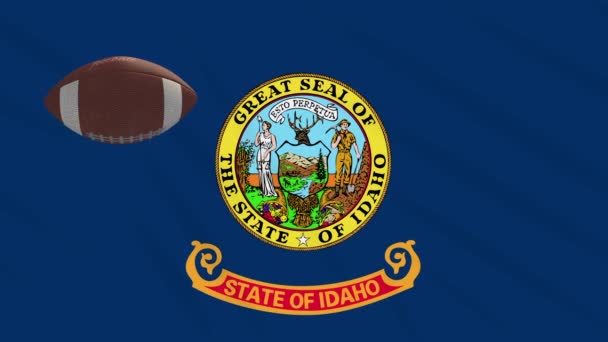 Idaho flag waving and american football ball rotates, loop — ストック動画