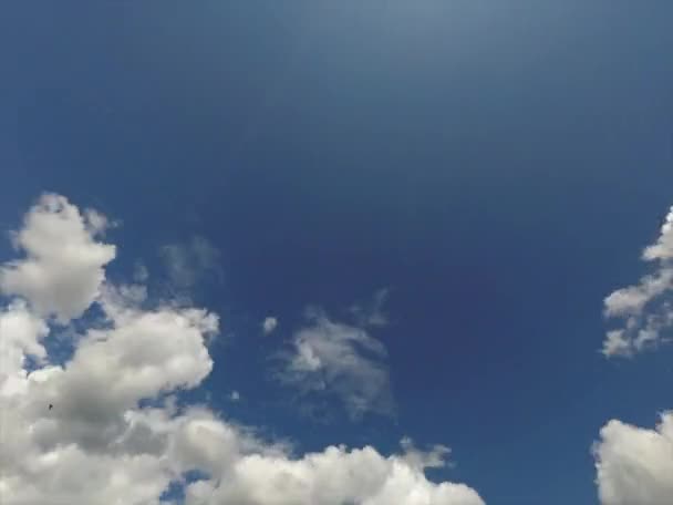 Fluffy white clouds float across sky turning into thunderclouds - time lapse 4k — 비디오