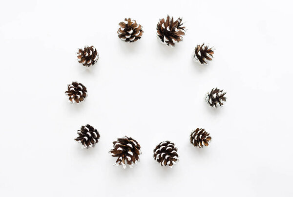 Christmas composition. Pine cones on white background. Copy space.