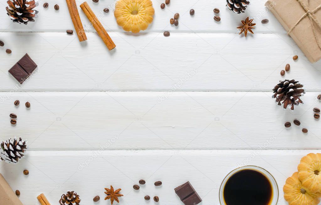 White cup of hot coffee with couple of croissants and chocolate. White wooden background.