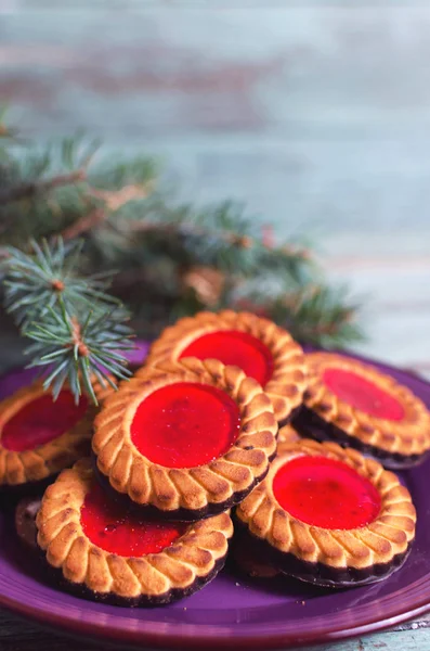 Christmas cookies. Cookies with raspberry jam on turicouse table background. Traditional Austrian biscuits filled.