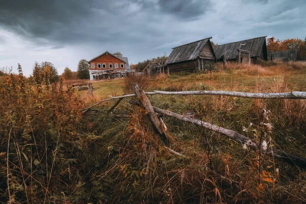 Dřevěné venkovské domy ve staré vesnici. Mračný podzimní den ve vesnici na venkově. — Stock fotografie