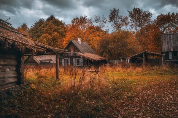 Wooden rustic houses in old village. Cloudy autumn day in a countryside mill village.