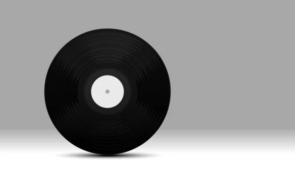 グレーの背景に黒いビニールの蓄音機のレコード — ストック写真