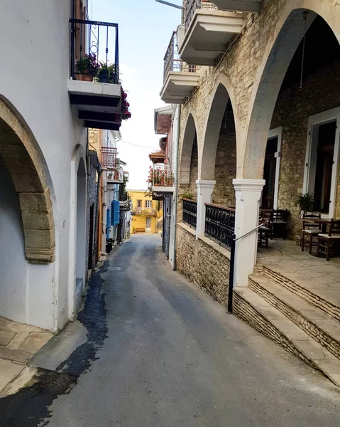 A street with a narrow road and nice houses built on it