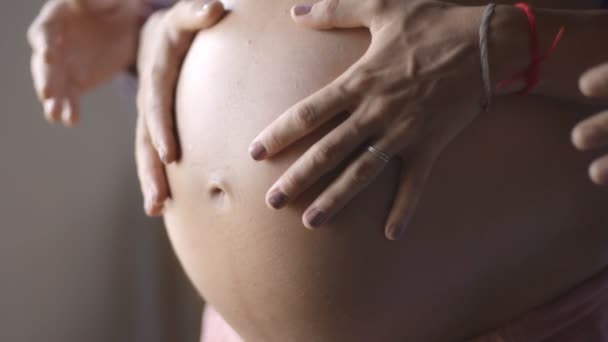 Mutti und Vati reichen schwangeren Bauch. Schwangeres Paar streichelt schwangeren Bauch. Glückliche Familie. Schwangerschaft, Mutterschaft, Mutterschaft, Menschen und Erwartungskonzept. — Stockvideo