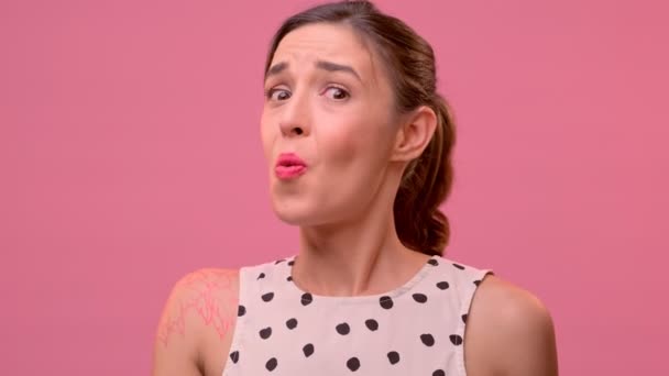 Portrait of happy young woman showing okay gesture on a pink background. — Stock Video
