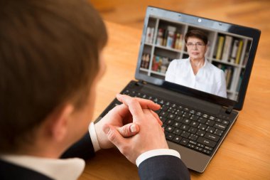 Online konferans. İş adamı iş ortağına bilgisayar kullanarak video görüşmesi yapıyor. Merkez ofis. Evden çalışmak.