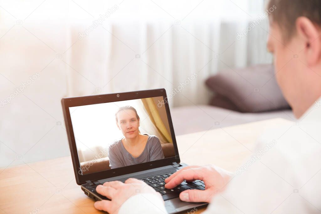 Man and woman communicating online by video call, webcam videochat. Home office. Working from home.