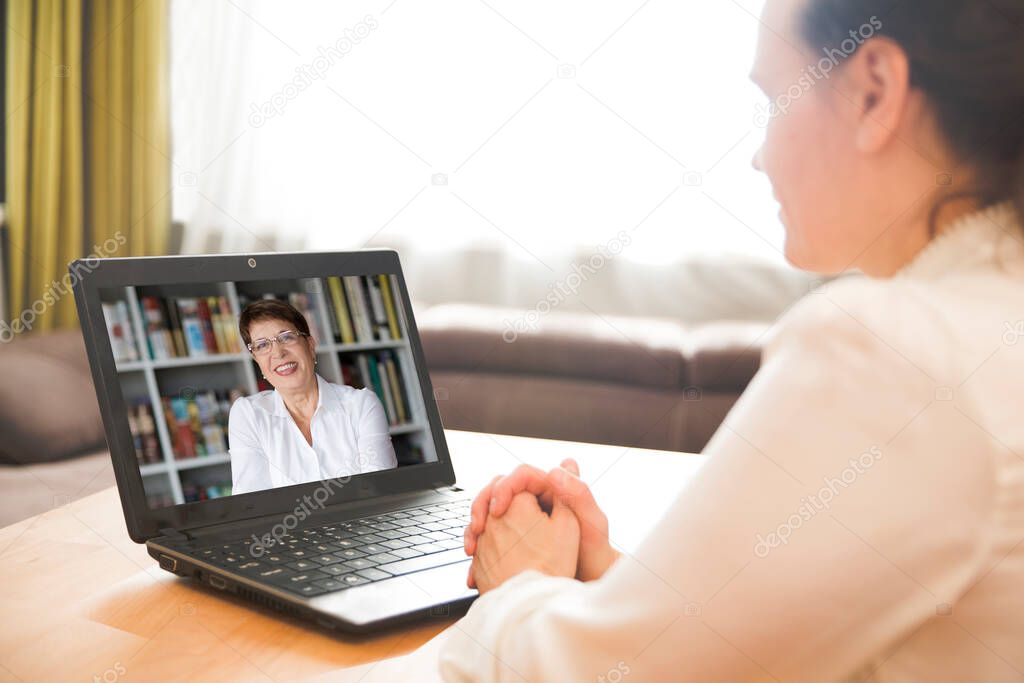 online conference. Businesswoman using laptop making video call to business partner. Home office. Working from home.