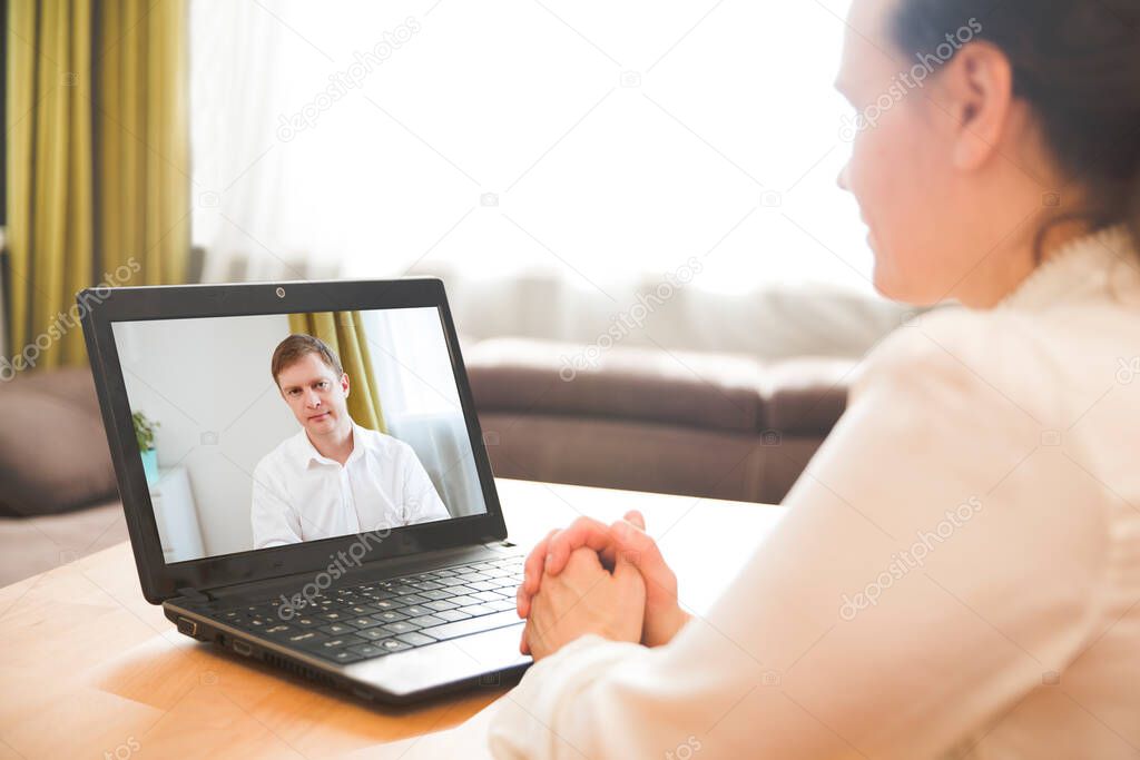 Man and woman communicating online by video call, webcam videochat. Home office. Working from home.