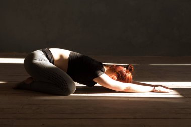  Evde idman yapmak yok. Evde vücut ağırlığı egzersizi. Evde esneme hareketleri yapan bir kadın. Sağlıklı ve spor yaşam tarzı. Sporcu kız yoga egzersizi yapıyor.. 