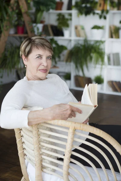 Happy Senior Woman Reading Book Indoors — Stock Photo, Image