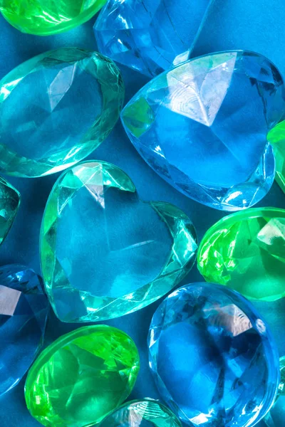 colored crystals of blue and green on a blue background