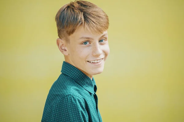 young man in blue shirt on yellow background