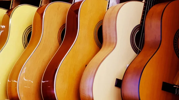 acoustic guitars stand in rows. musical instruments. High quality photo