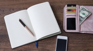 defter kalem, m-cüzdan ile para ve indirim kartları, telefon, ahşap arka plan ile