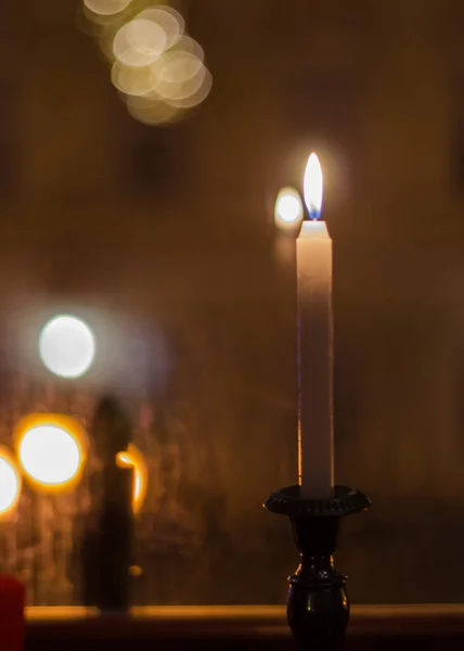 background with reflection of candles in the window, in the evening, close-up