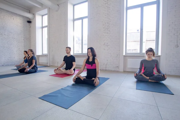 yoga class training, morning exercises in white interior