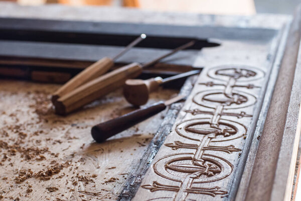 Woodcarving workshop, close up picture of tools and wood