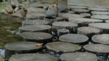 Uzun yürüyüşe çıkan kimse bot geçiş nehir, dağ dere üzerinde ahşap köprü yakın çekim