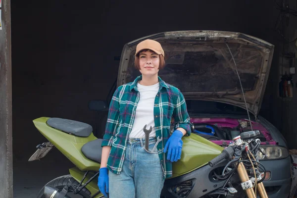 Female mechanic fixing car  in a garage