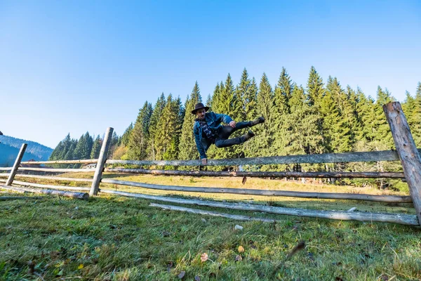 Mladý Muž Farmář Džínové Bundě Kovbojský Klobouk Skok Přes Plot — Stock fotografie