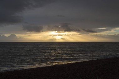 Sabah gündoğumu Aldeburgh, Suffolk, İngiltere'de bulutlara parlıyor Güneş ışınları ile